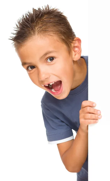 Little boy is looking out from the blank banner — Stock Photo, Image