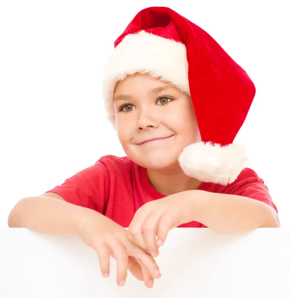 Noel Baba şapkası, küçük kız Pano düzenliyor — Stok fotoğraf