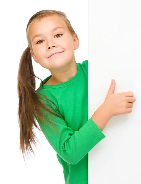 Little girl is looking from out blank board — Stock Photo, Image