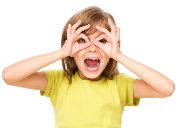 Happy little girl is showing glasses gesture — Stock Photo, Image