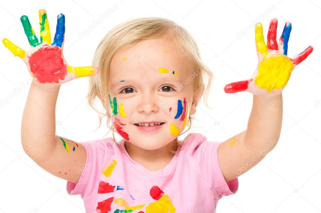 Portrait of a cute little girl playing with paints