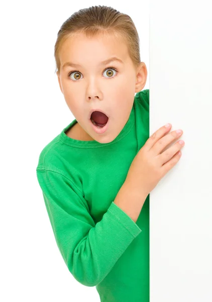 Little girl is looking out from the blank banner Stock Image