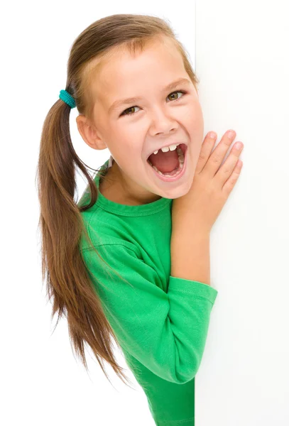 Petite fille regarde à partir du tableau blanc — Photo