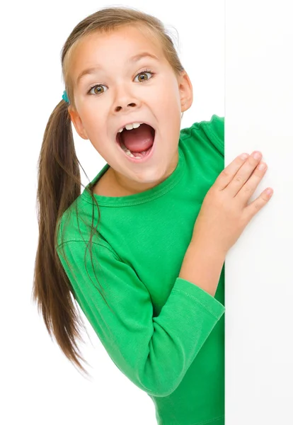 Little girl is looking from out blank board — Stock Photo, Image