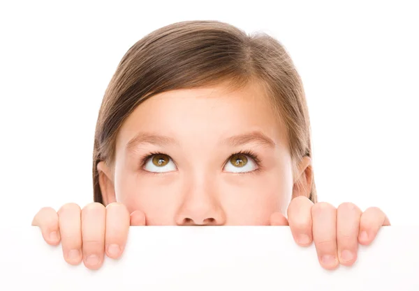 Little girl is looking from out blank board — Stock Photo, Image