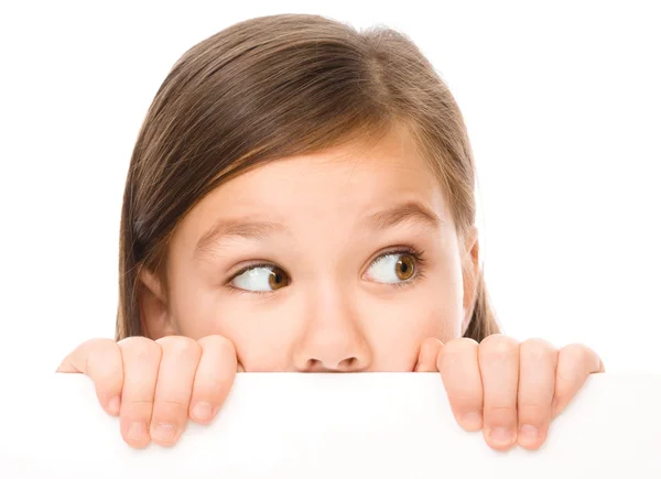 Little girl is looking from out blank board — Stock Photo, Image