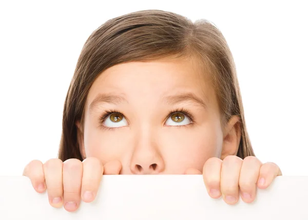 Little girl is looking from out blank board — Stock Photo, Image