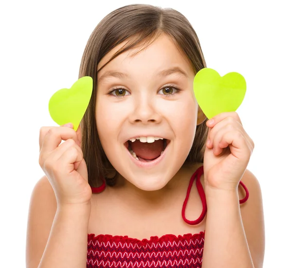 Little girl is holding hearts near her eyes — Stock Photo, Image