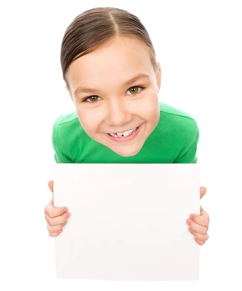 Happy little girl is holding blank board — Stock Photo, Image