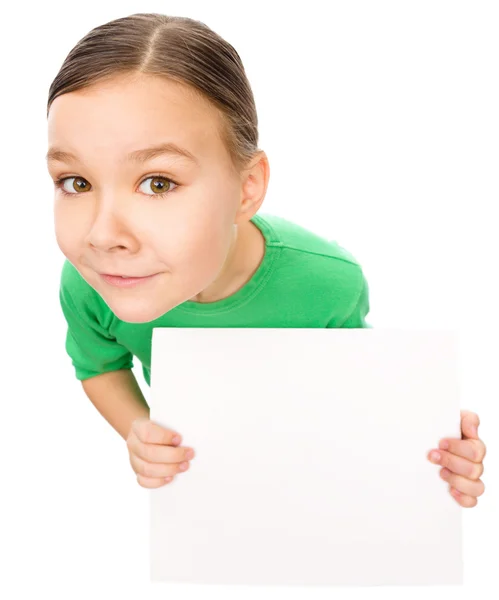 Happy little girl is holding blank board — Stock Photo, Image