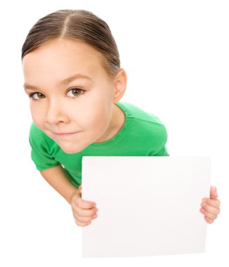 Happy little girl is holding blank board clipart