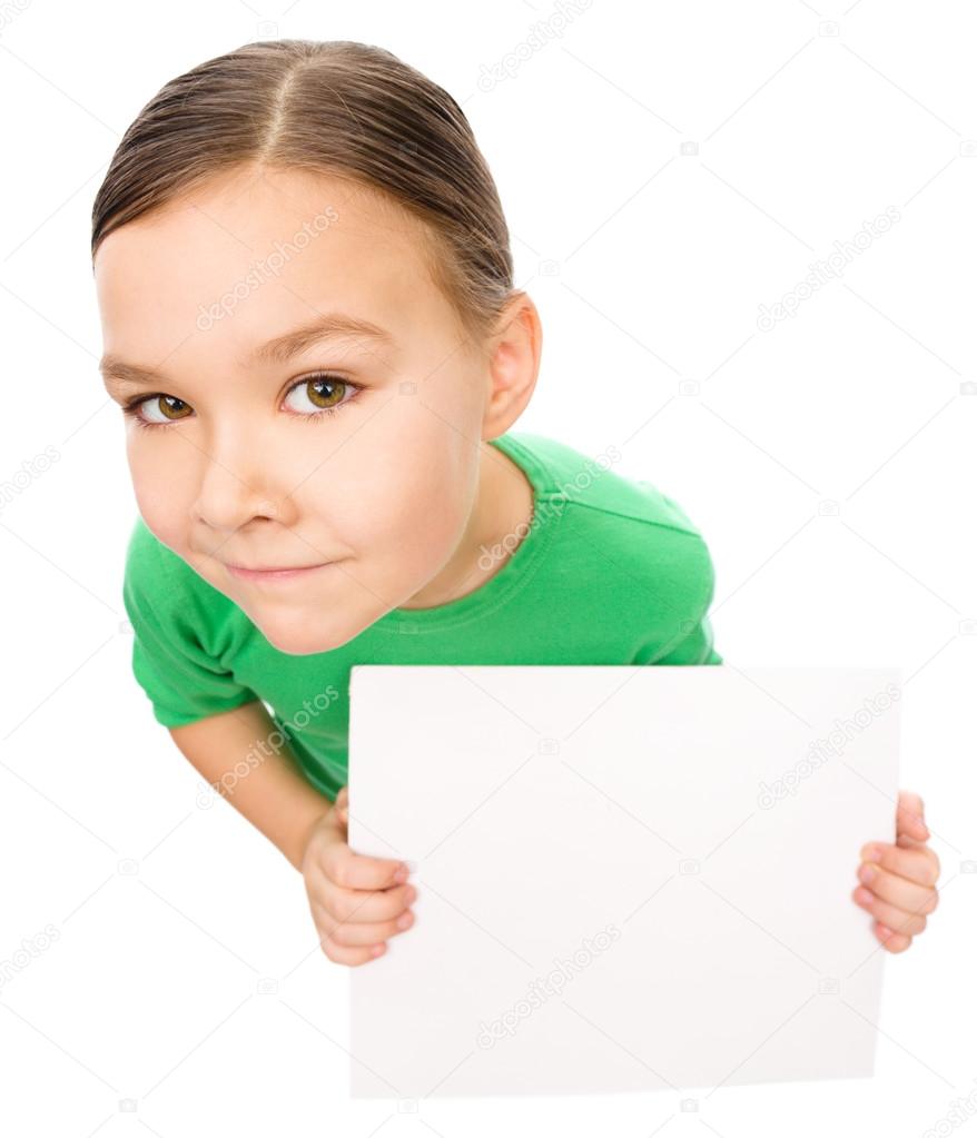 Happy little girl is holding blank board