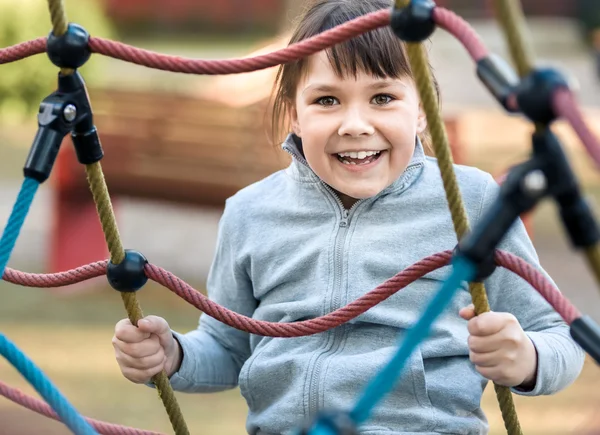 Cute little girl is playing in playground — Stock Photo, Image