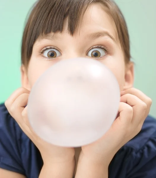 Little girl is blowing big bubble gum — Stock Photo, Image