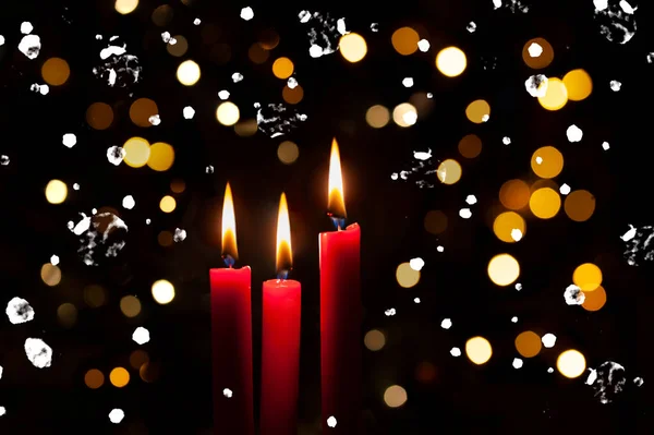 Three Red Lit Candles Colorful Bokeh Background Spots Snow Flakes — Stock Photo, Image