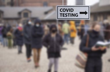 İnsanlar Coronavirus Covid-19 test ya da aşı testleri için sırada bekliyorlar. Seçici odaklı bulanık resim.