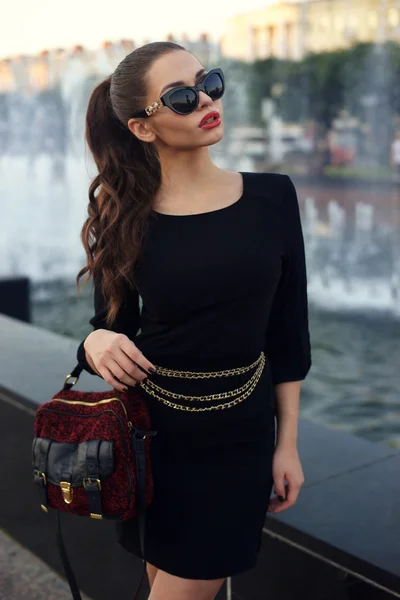 Stylish girl in short black dress. — Stock Photo, Image