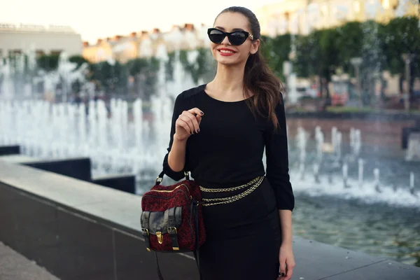 Stylish girl in short black dress. — Stock Photo, Image