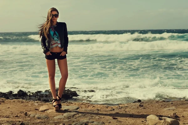 stylish woman at ocean coast