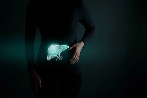 Illustration of liver detox with highlighted organ and contrast hands on dark background. Low key photo with copy space toned in dark green colors.