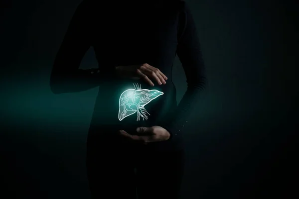 Illustration of liver detox with highlighted organ and contrast hands on dark background. Low key photo with copy space toned in dark green colors.