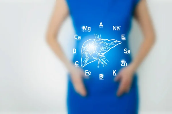 Graphic visualization of healthy human liver surrounded with icons of vitamins and minerals.  Blurred female figure, positive blue bright color of recovery, health and detox concept.