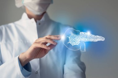Female doctor touches virtual Pancreas in hand. Blurred photo, handrawn human organ, highlighted blue as symbol of recovery. Healthcare hospital service concept stock photo clipart