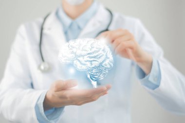 Female doctor holding virtual volumetric drawing of  Brain in hand. Handrawn human organ, copy space on right side, raw photo colors. Healthcare hospital service concept stock photo clipart