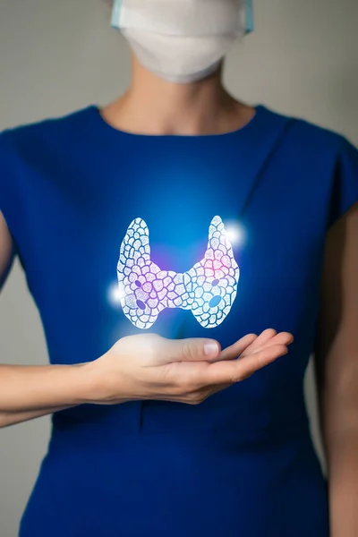 Woman in blue clothes holding virtual Thyroid Gland in hand. Handrawn human organ, detox and healthcare, healthcare hospital service concept stock photo