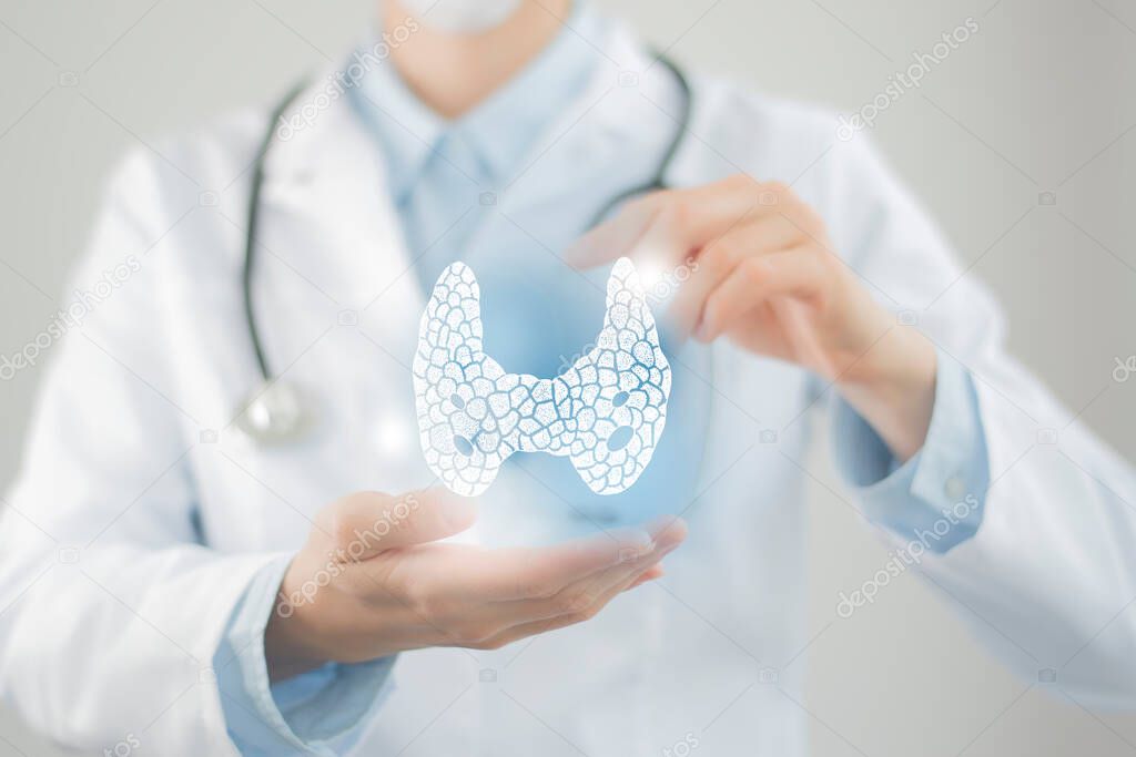 Female doctor holding virtual Thyroid Gland in hand. Handrawn human organ, blurred photo, raw colors. Healthcare hospital service concept stock photo