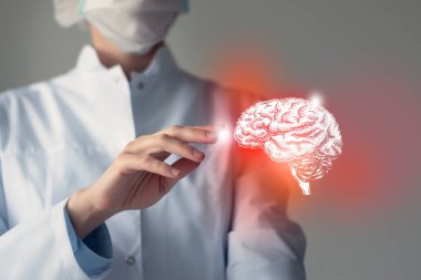 Female doctor touches virtual red  Brain in hand. Blurred photo, handrawn human organ, highlighted red as symbol of disease. Healthcare hospital service concept stock photo clipart