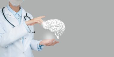 Female doctor holding virtual volumetric drawing of  Brain in hand. Handrawn human organ, copy space on right side, raw photo colors. Healthcare hospital service concept stock photo clipart
