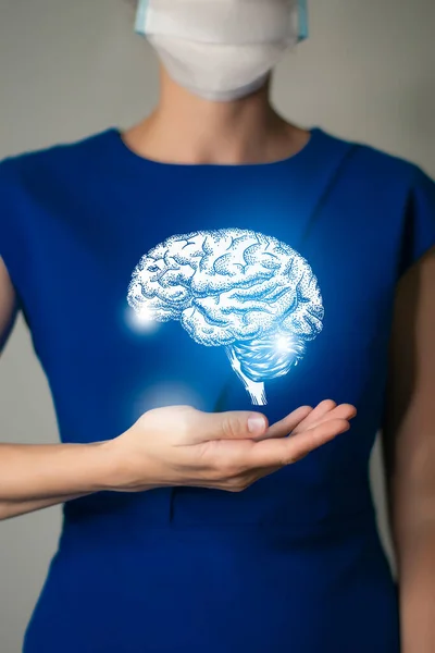 Woman in blue clothes holding virtual Brain in hand. Handrawn human organ, detox and healthcare, healthcare hospital service concept stock photo