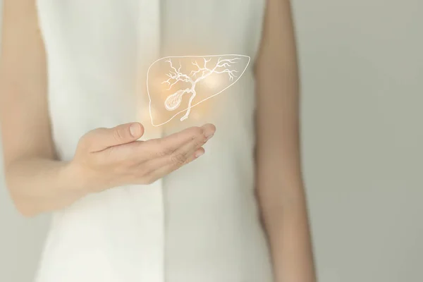 Beyaz elbiseli tanınmayan bir kadın hasta, ellerinde altı çizilmiş safra kesesi var. İnsan sindirim sistemi kavramı.