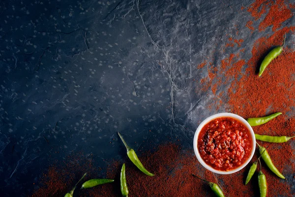 Chili und Knoblauch auf dunkler Schiefertafel Stockfoto