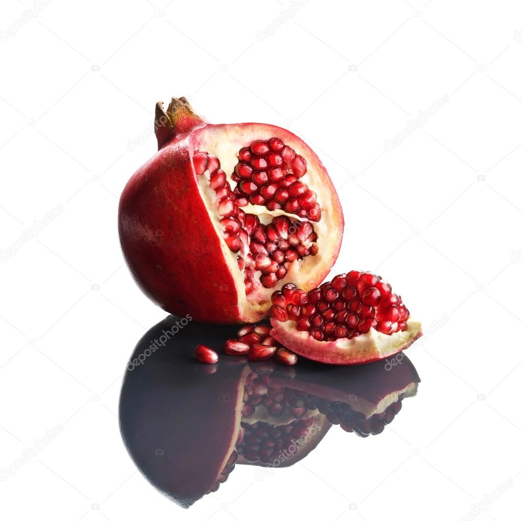 Pomegranate opened up on reflective surface
