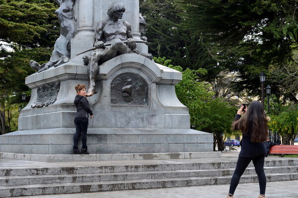  Tourists at monument to Fernando Magellan in Punta arenas.