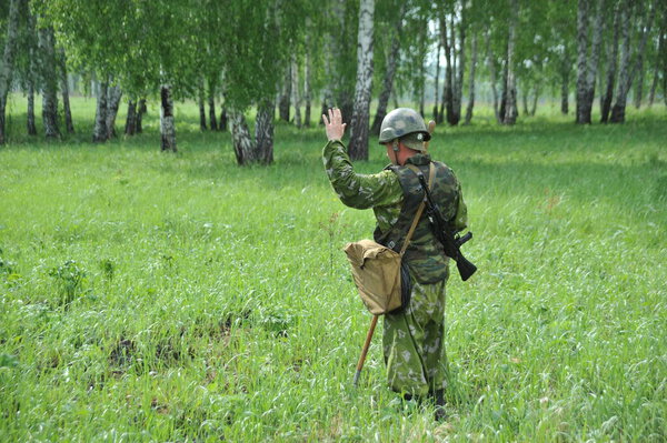 JURGA, SIBERIA, RUSSIA - JUNE 6,2011:The sapper gives a sign about the detected mine on the field