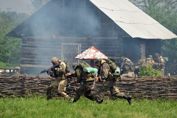 ISKITIM, SIBERIA, RUSSIA - JUNE 8,2011:Soldiers of a special forces unit practice combat operations in a village at a military training ground