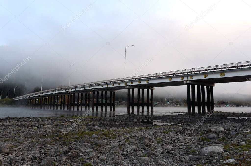 ALTAI REPUBLIC, RUSSIA - SEPTEMBER 28, 2020:Bridge over the Biya River at its source on Lake Teletskoye in the village of Iogach. Altai Republic