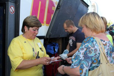 MOSCOW, RUSSIA-31 Temmuz 2012: Platform kontrolörü otobüse binmeden önce yolcuların biletlerini kontrol eder
