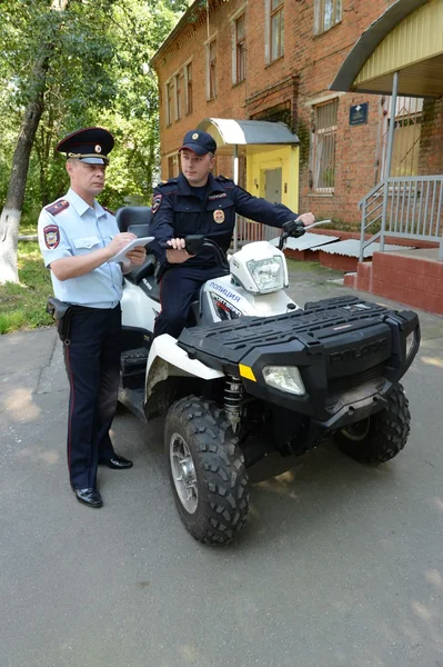 警察は、quadrocycle のヒムキの郊外の町の通りをパトロールします。. — ストック写真