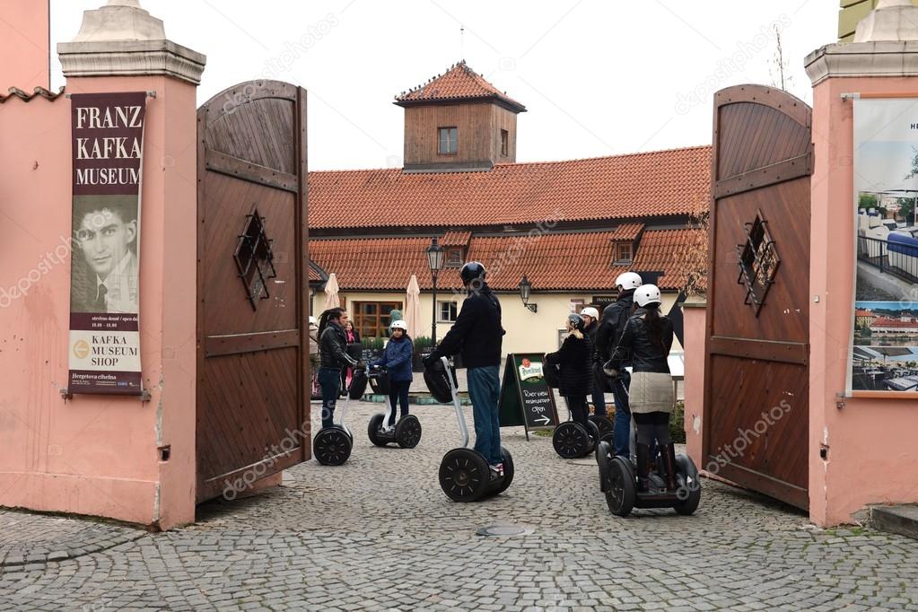 Tourists on Segways in the Museum of Kafka.