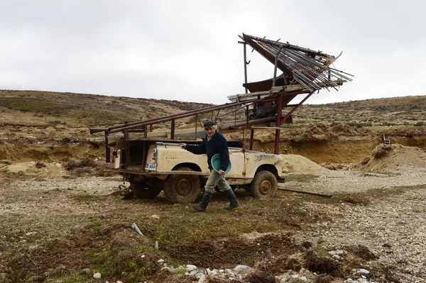 Gold Digger Shows Tourists Alluvial Gold Sand Mined in the Mine on