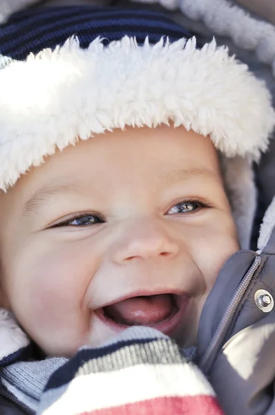 Portrait of smiling cute little baby boy wearing warm winter hat Stock Picture