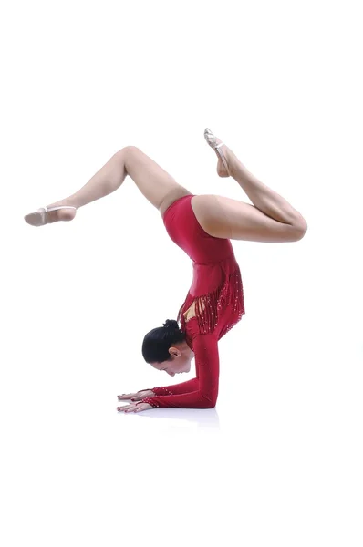 Beautiful artistic female gymnast working out, performing art gymnastics element — Stock Photo, Image