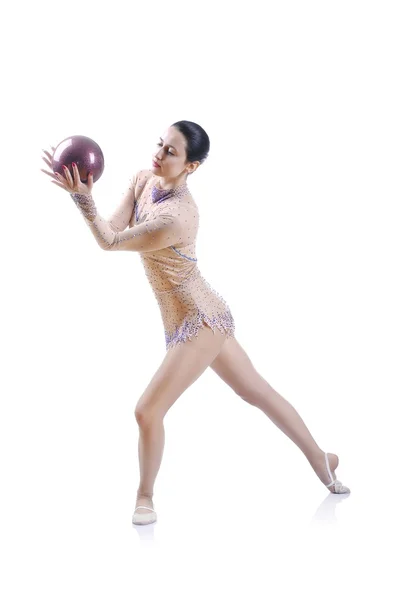 Beautiful artistic female gymnast working out, performing art gymnastics element — Stock Photo, Image