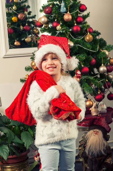 Красивая Маленькая Девочка Шляпе Санта Клауса Подарочной Сумке Стоящей Рядом — стоковое фото