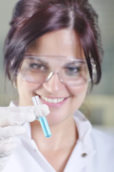 Attractive young PhD student scientist observing the blue indica — Stock Photo, Image