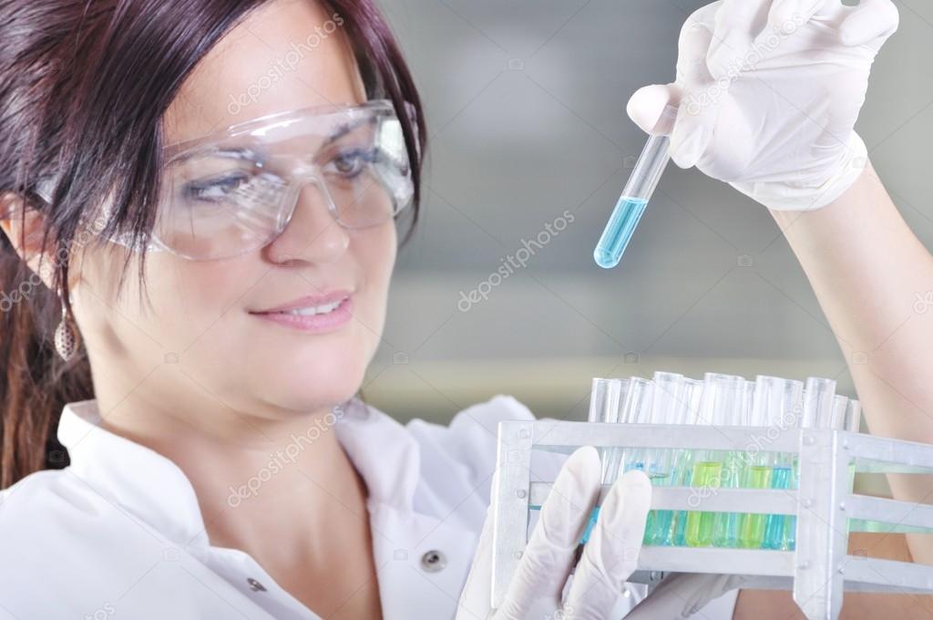 Attractive young PhD student scientist observing the blue indica
